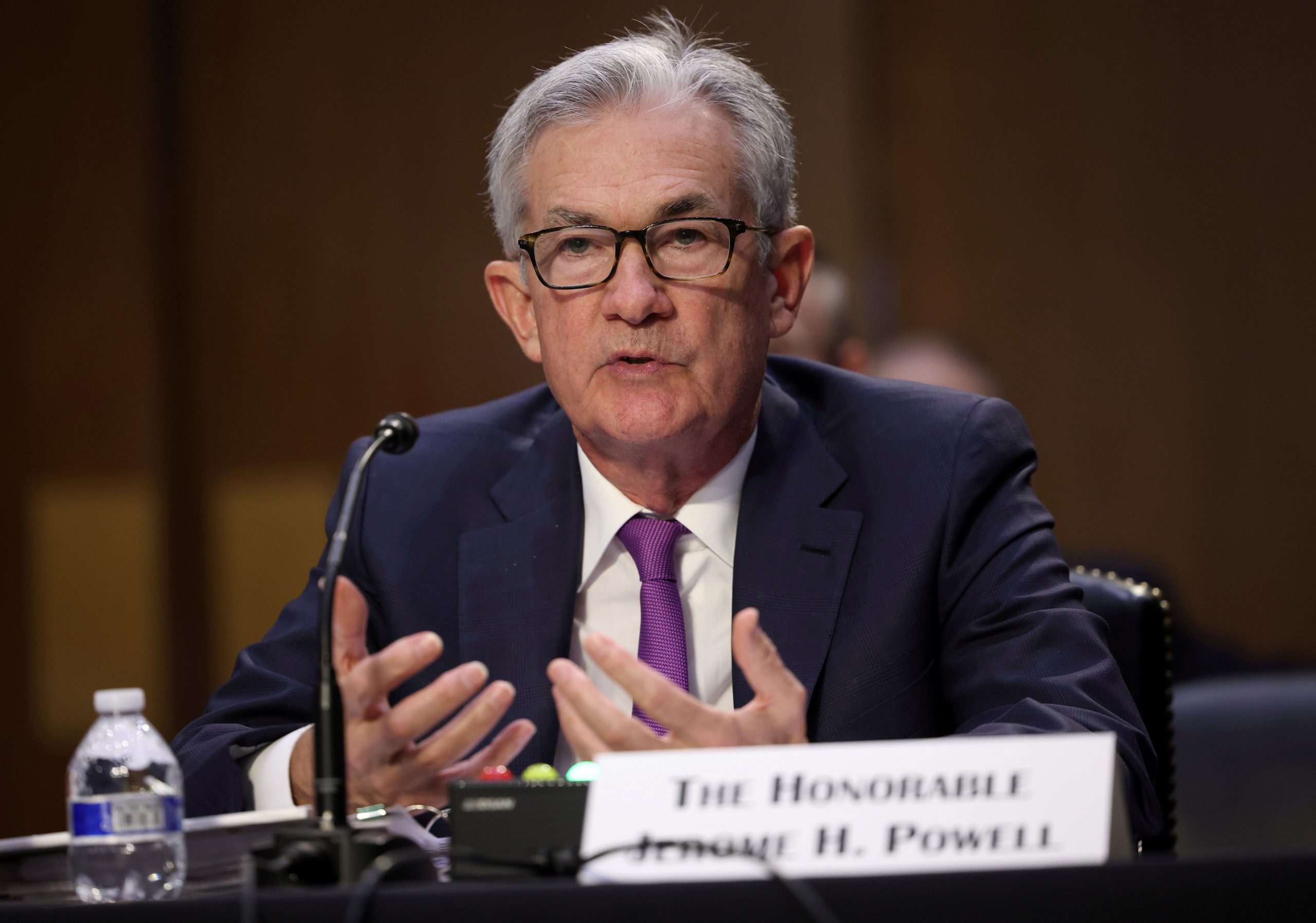 Fed to dial back bond purchases, maintain low interest rates