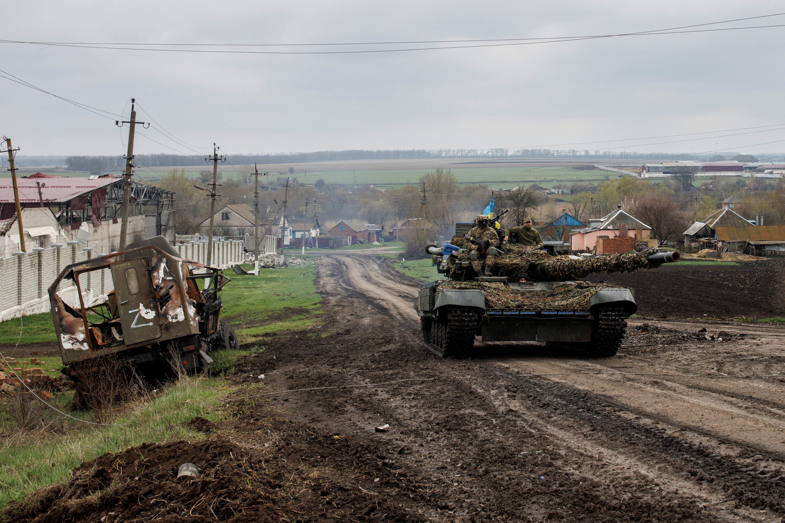 Recaptured Ukrainian village left with wrecked tanks, bodies and questions