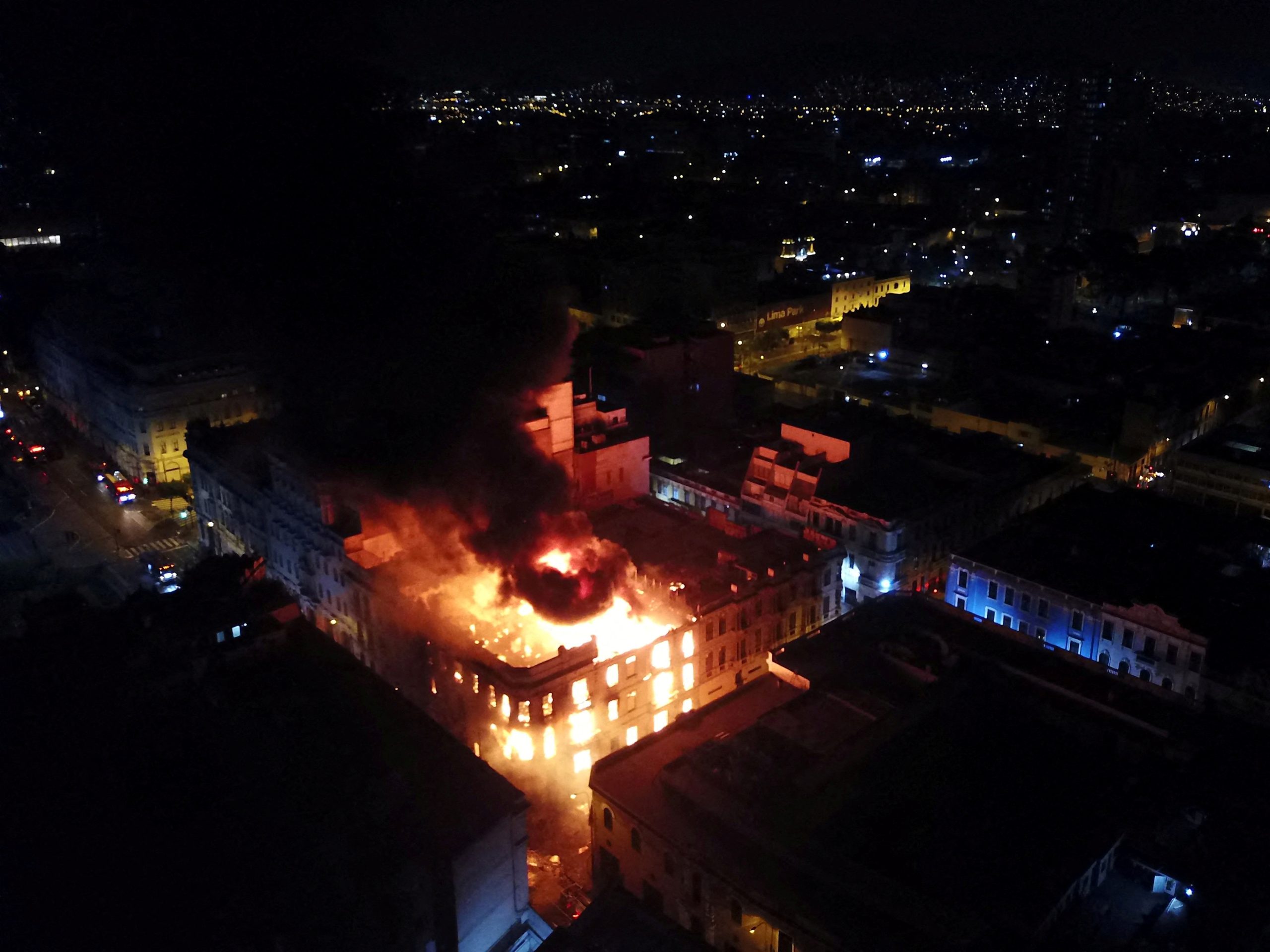 Thousands march on Peru’s capital as unrest spreads, building set ablaze